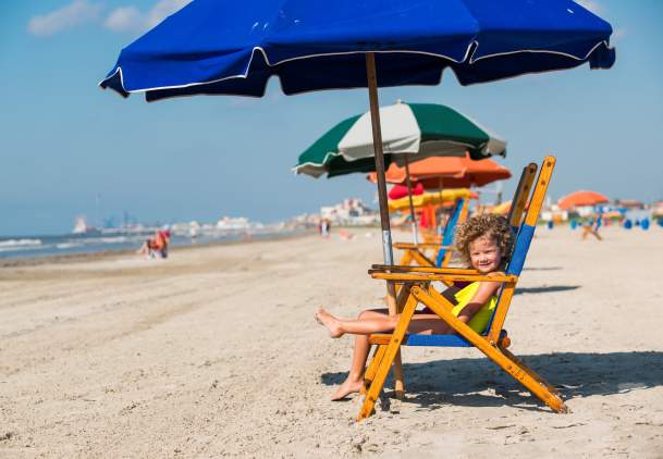 Kids enjoying the beach chairs along Stewart Beach in Galveston, TX